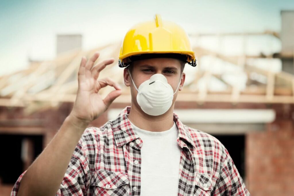construction site safety equipment: worker wearing a protective mask